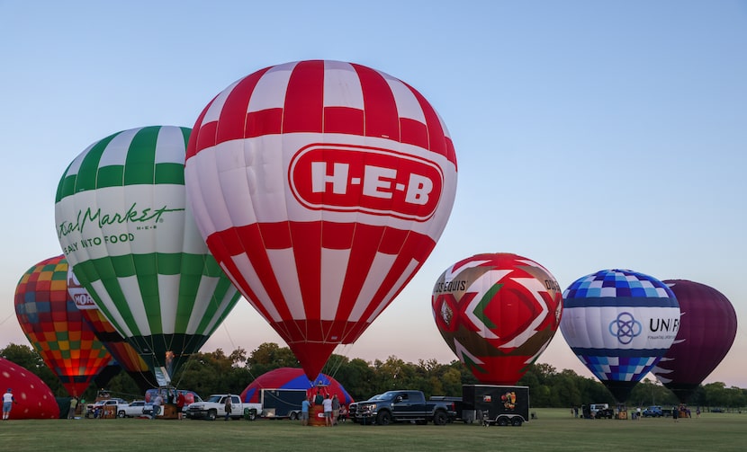 Hot air balloons inflate in preparation for a visual performance with the Plano Symphony...