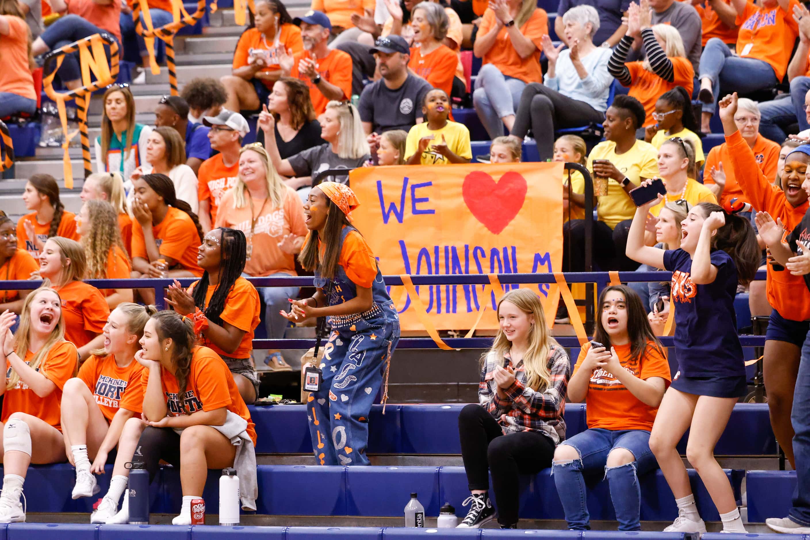 McKinney North students and fans jump to their feet to cheer for a point against Lovejoy at...