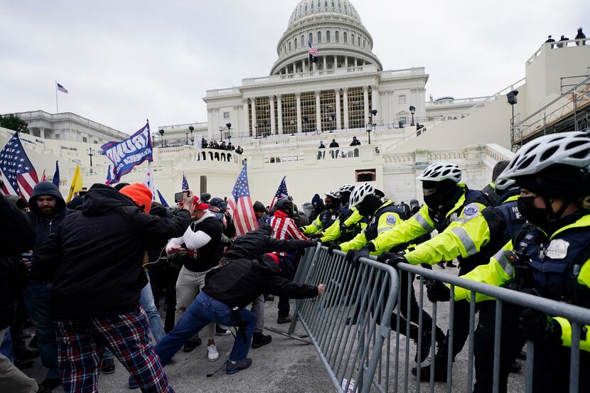 Insurrectionists loyal to President Donald Trump tried to break through a police barrier on...