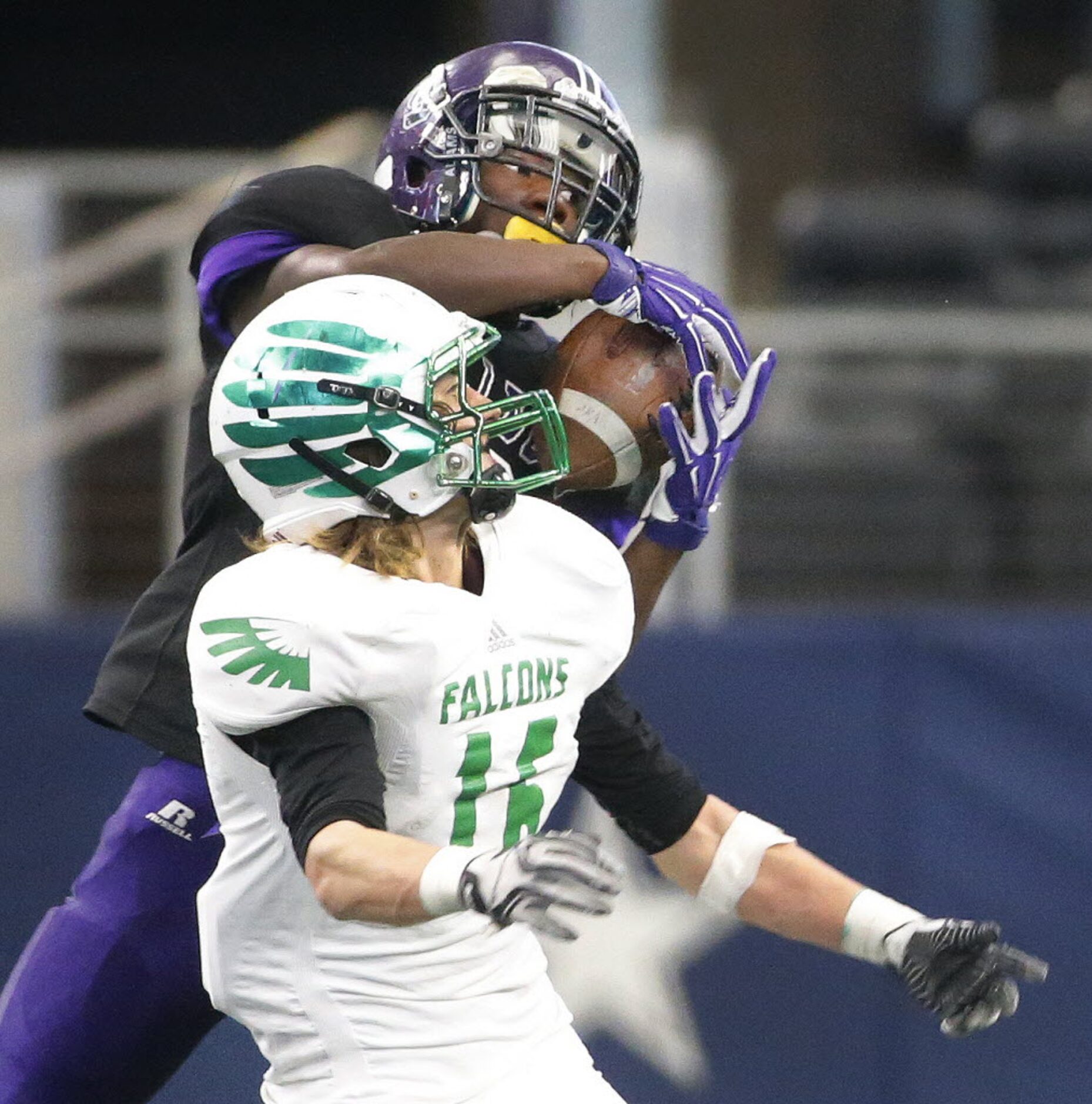 Everman receiver Deante Toliver goes high to snag a pass in the fourth quarter over the...