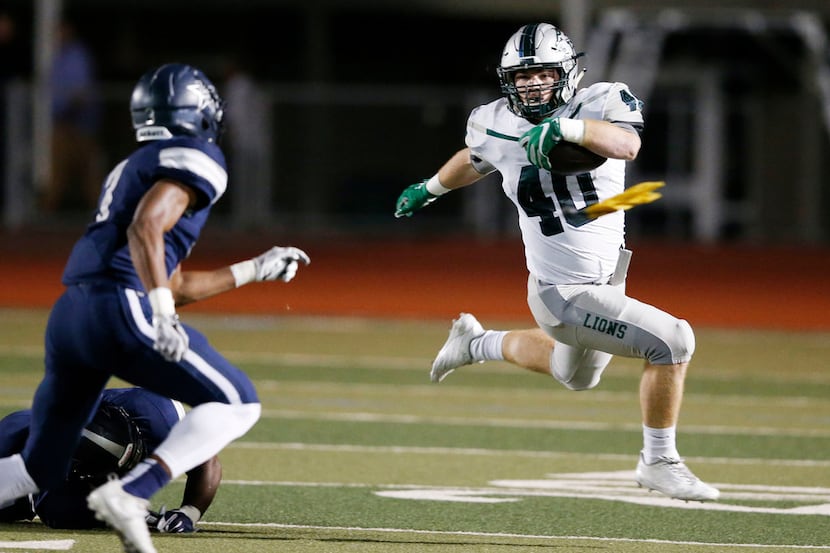 Frisco Reedy's Will Harbour (40) leaps as he attempts to run past Frisco Lone Star's Trey...