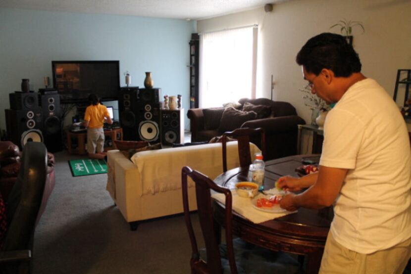 Francisco Gonzalez makes dinner for his daughter Leah Gonzalez in the dining room of thier...