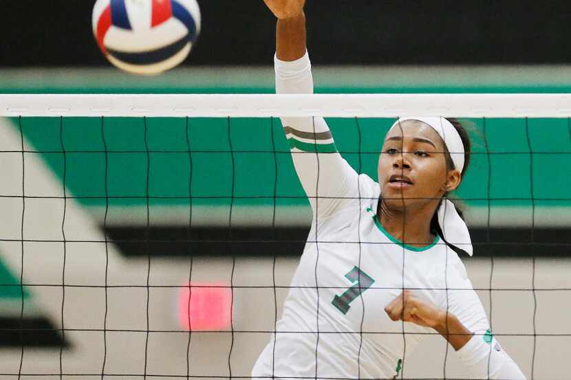 Southlake Carroll junior Asjia O'Neal spikes the ball during a match on September 20, 2016....