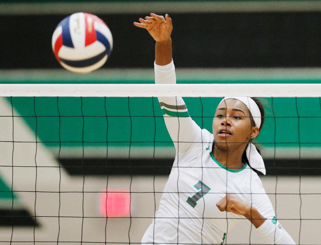 Southlake Carroll junior Asjia O'Neal spikes the ball during a match on September 20, 2016....