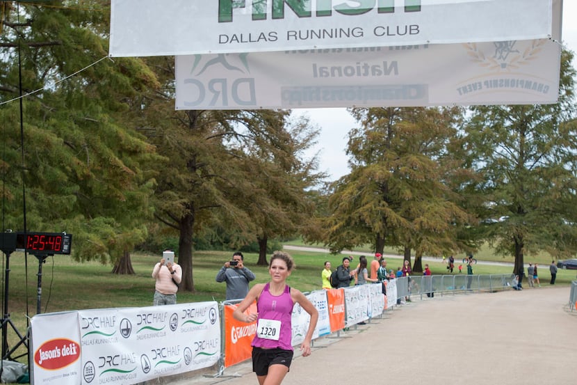 First place female finisher Nicole Kalogeropoulos (cq) crosses the finish line at the Dallas...