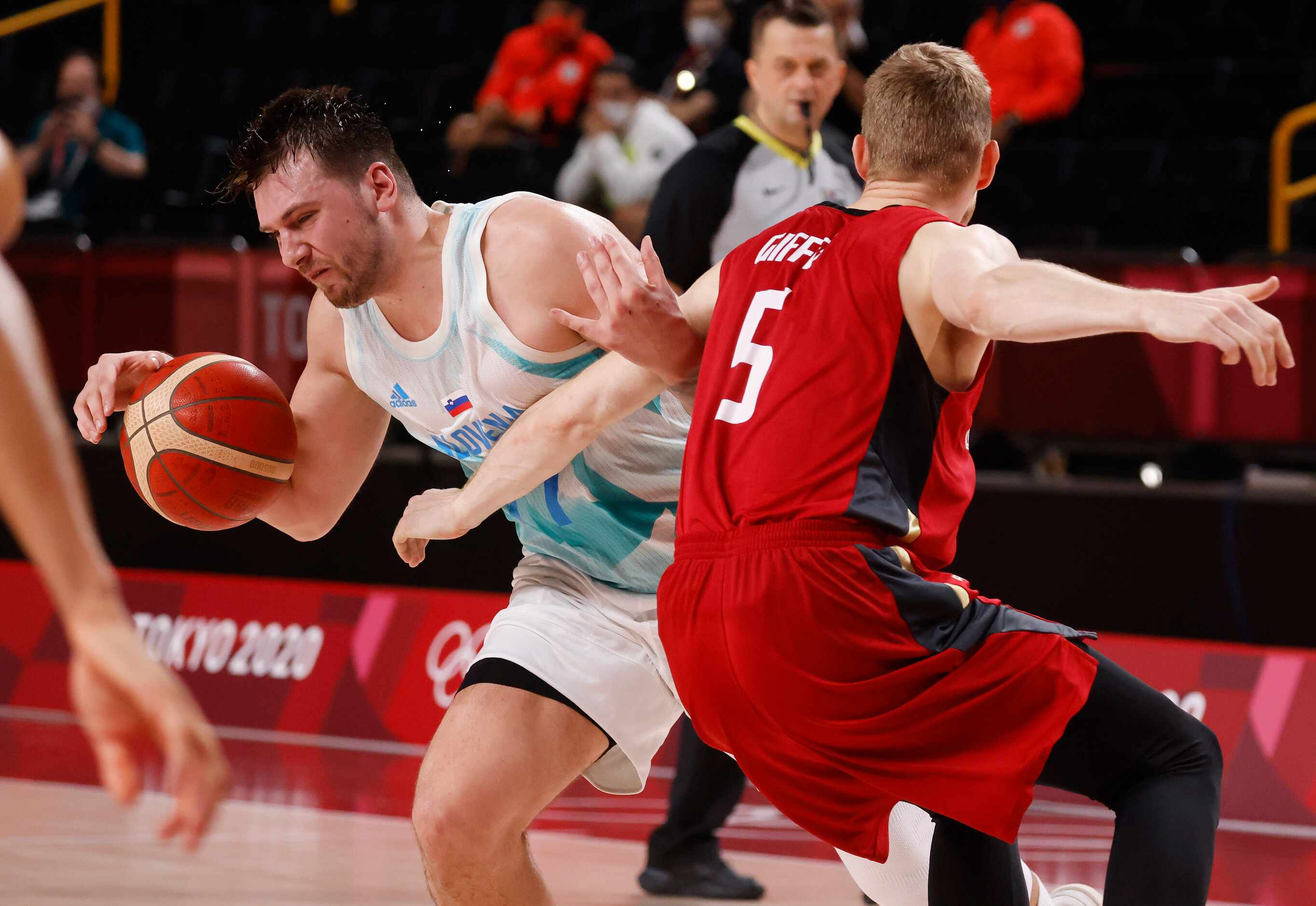 Slovenia’s Luka Doncic (77) attempts to get by Germany’s Niels Giffey (5) during the second...