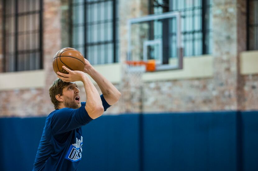 Dallas Mavericks forward Dirk Nowitzki shoots free throws as he warms up on the team's...