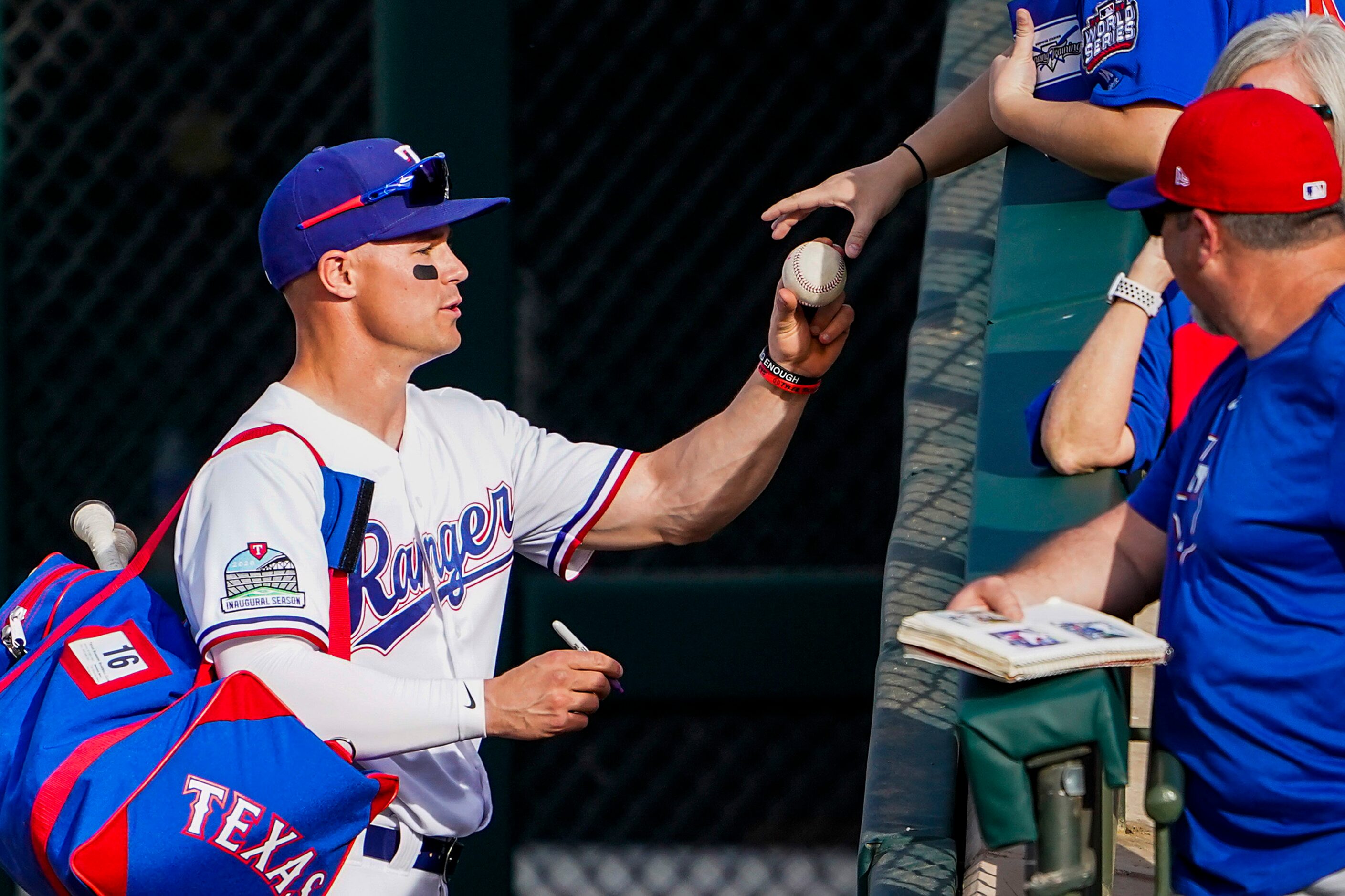 Texas Rangers outfielder Scott Heineman signs autographs after a 13-1 victory over the...