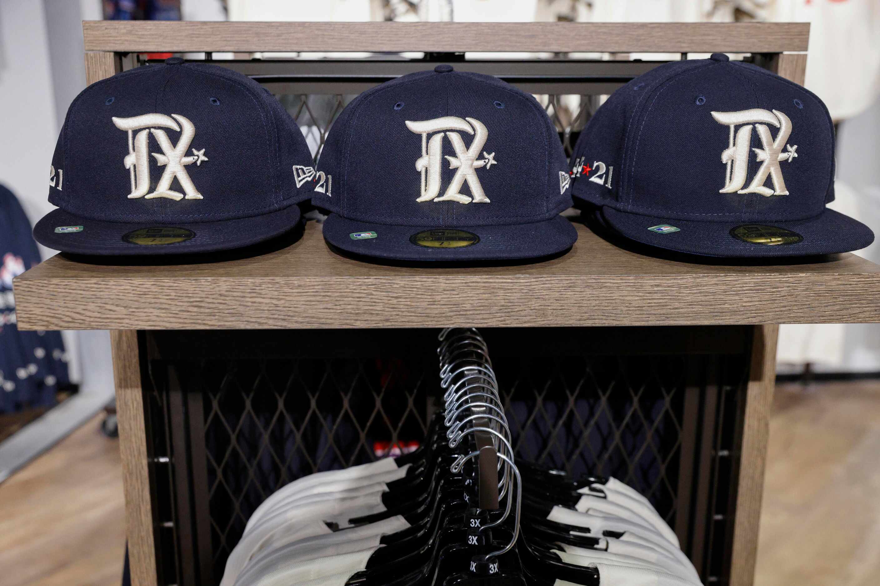 New Texas Rangers City Connect hats sit for sale on a shelf at Globe Life Field on Monday,...