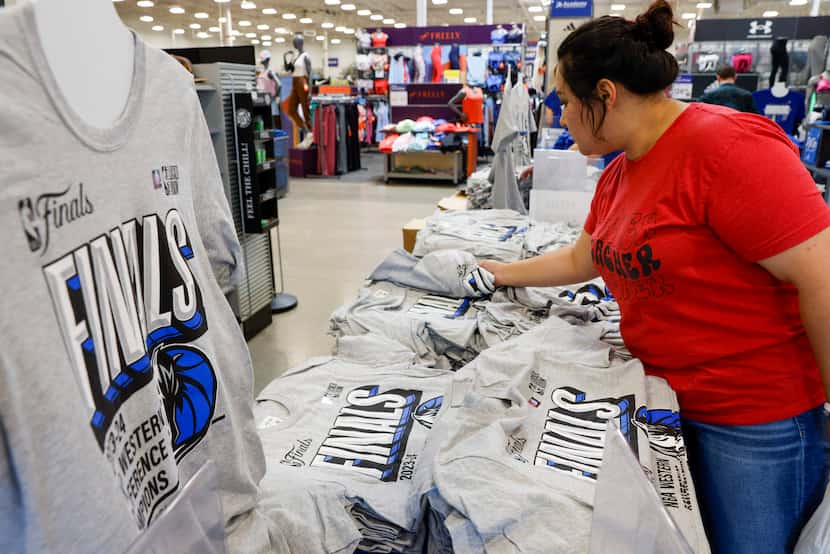 Cristal Soto of Dallas shops Dallas Mavericks NBA Finals shirts at an Academy Sports +...
