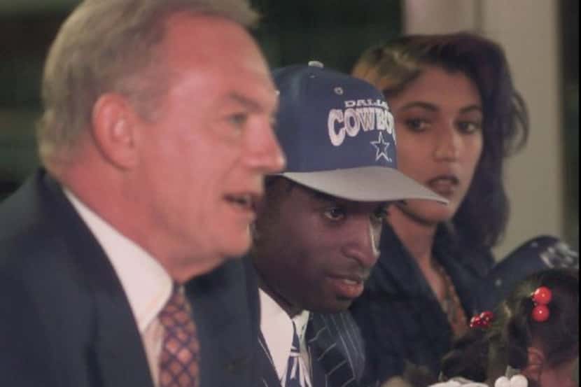 ORG XMIT: IRV104 The newest Dallas Cowboys player Deion Sanders, center, listens to Cowboys...