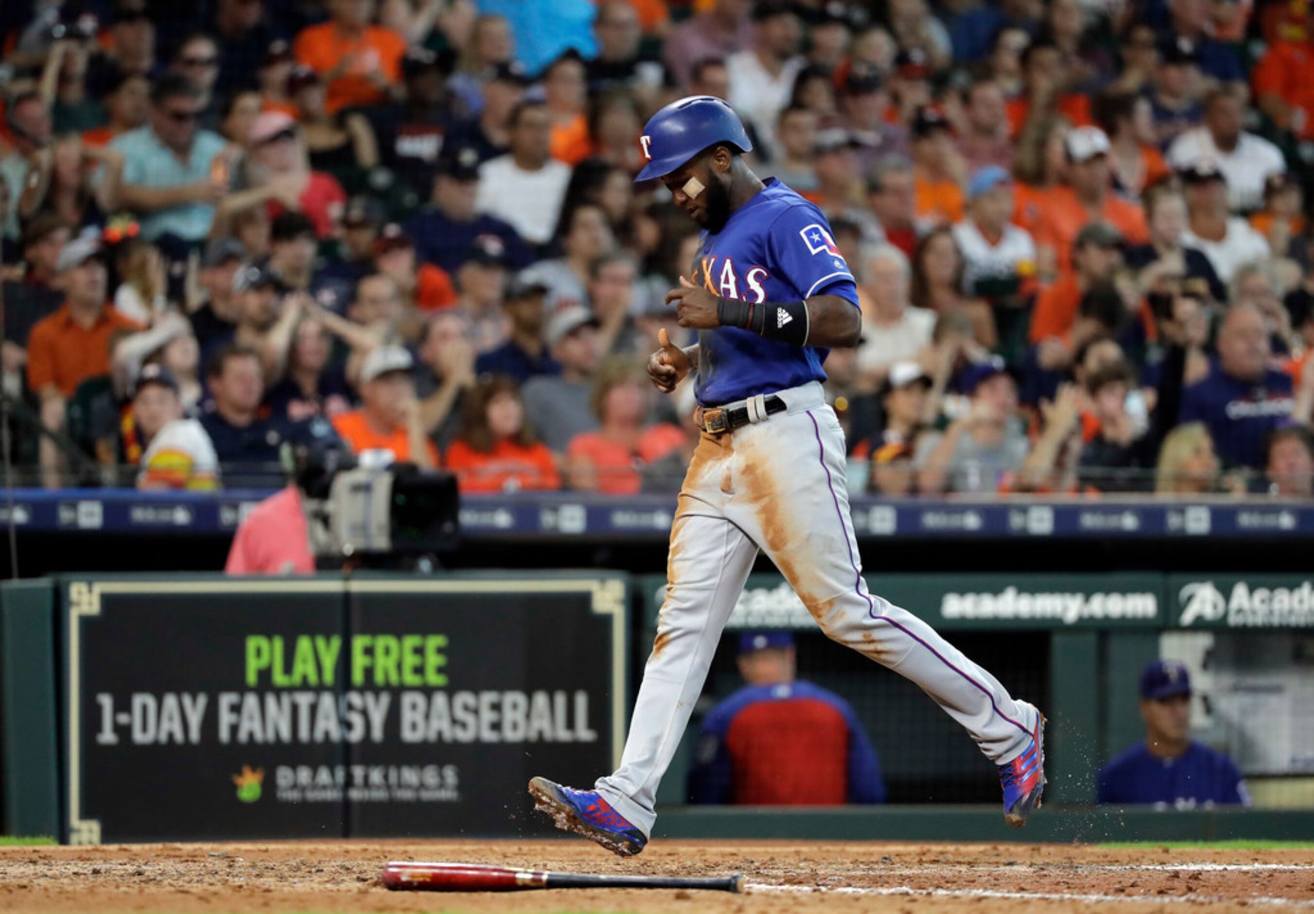 Texas Rangers' Jurickson Profar scores during the sixth inning of a baseball game against...