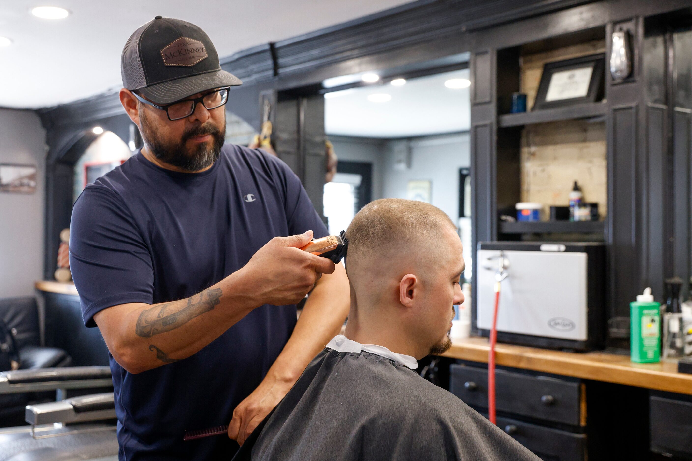 Owner Benjamin Salas cuts the hair of  at Kutz N Fadez on Wednesday, May 24, 2023, in...