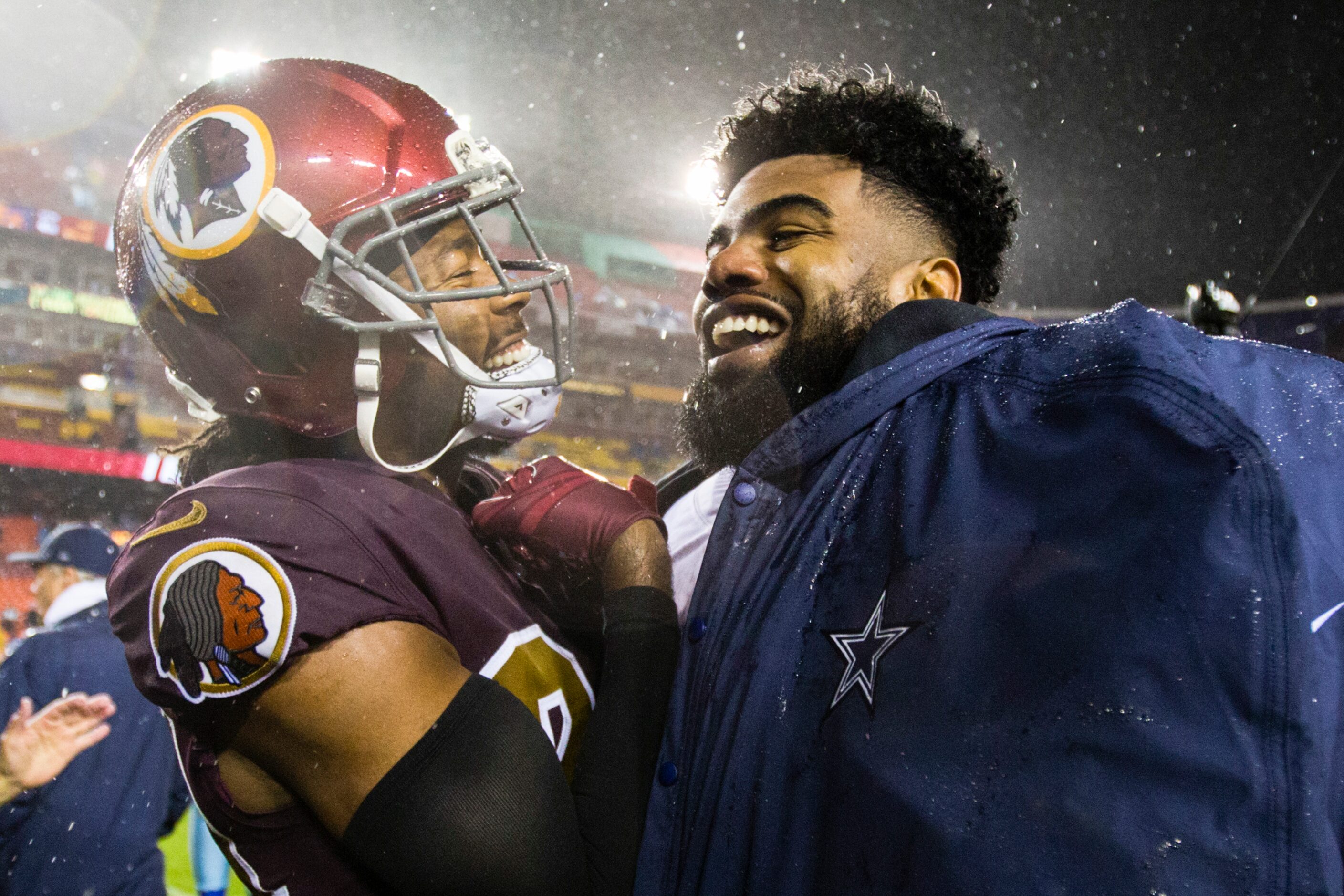 Dallas Cowboys running back Ezekiel Elliott (21) jokes with Washington Redskins cornerback...