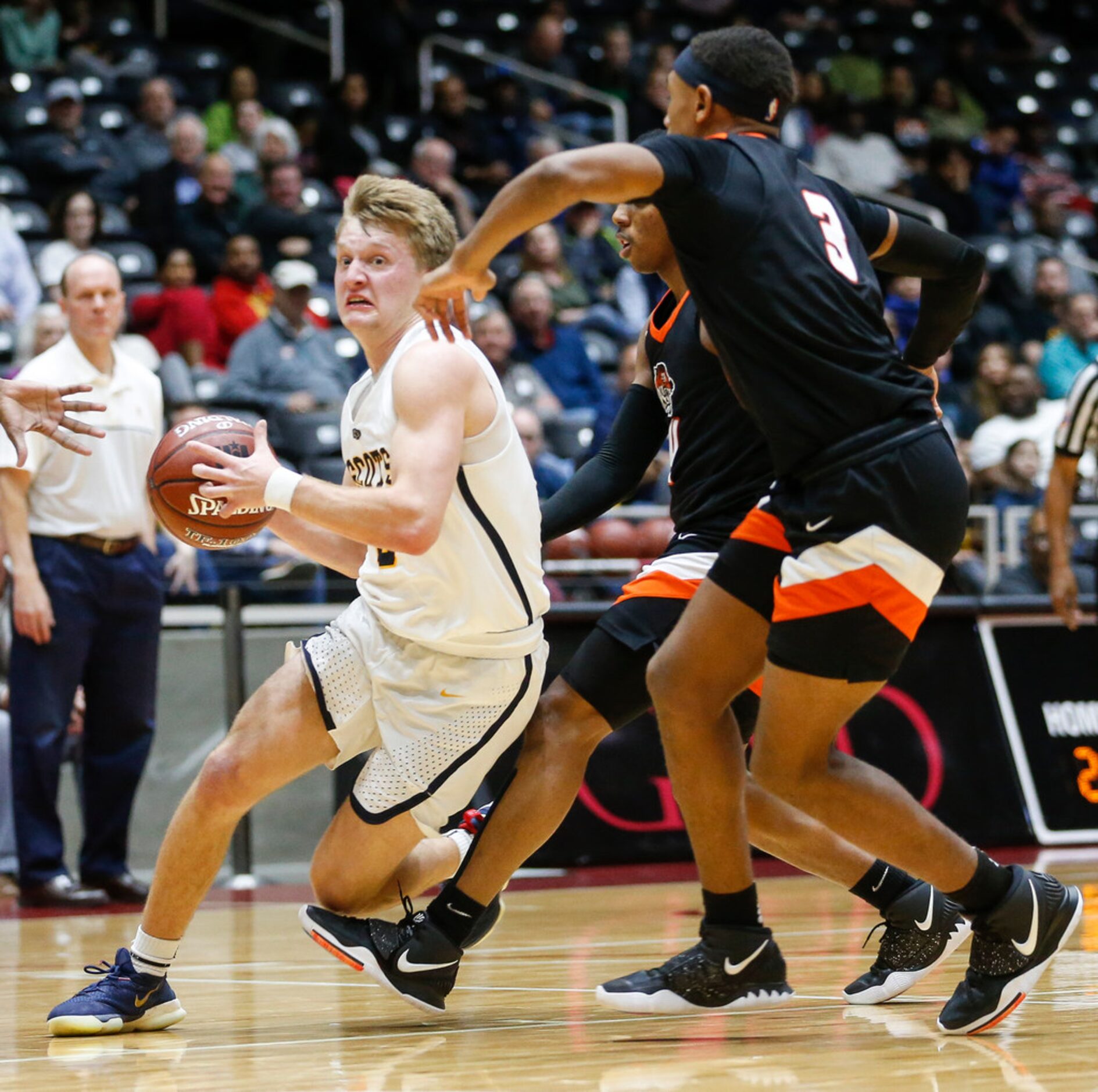 Highland Park's Drew Scott drives to the basket past Lancaster's Markeis Sykes (3) during...