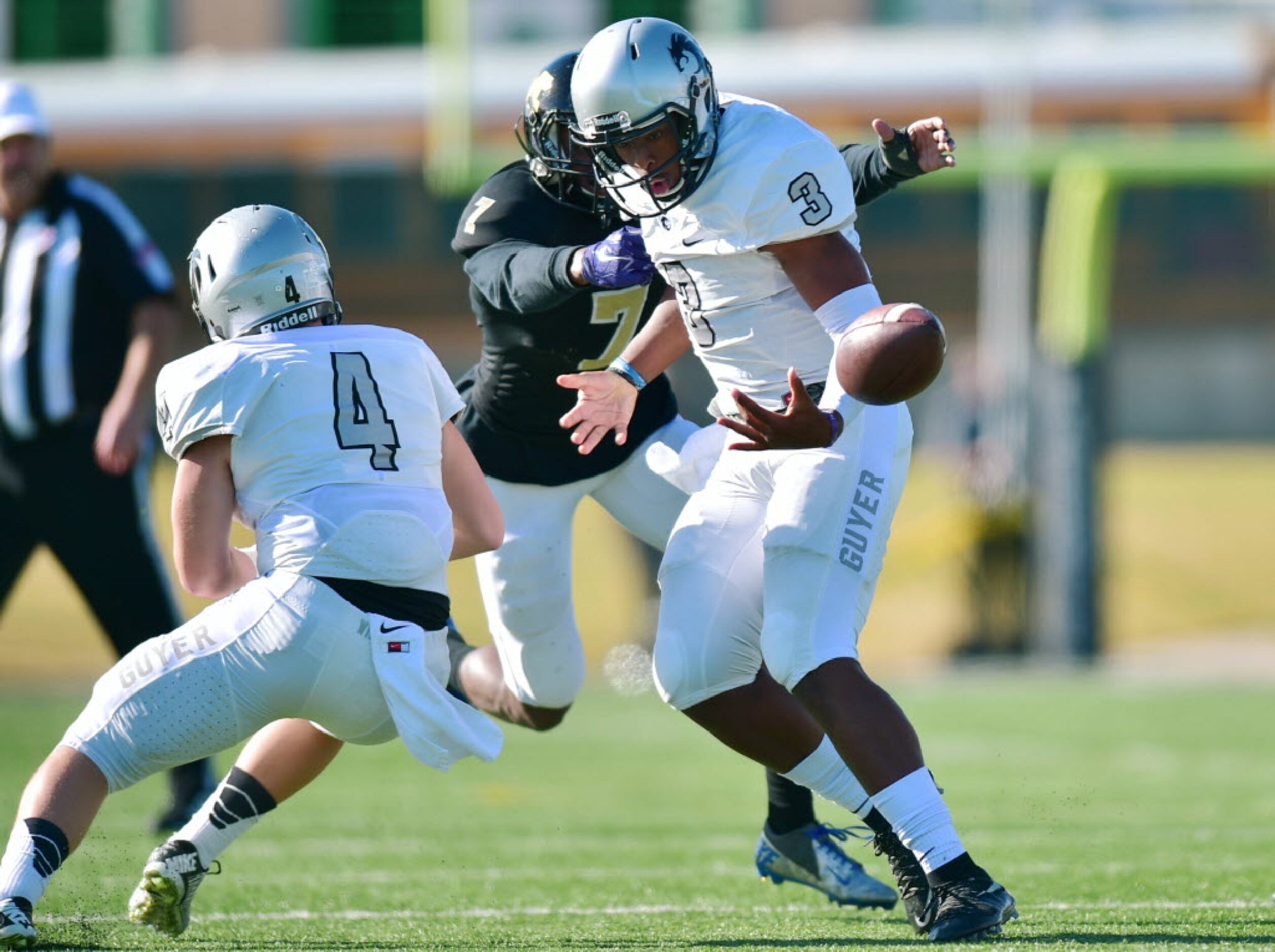 Guyer junior quarterback Shawn Robinson (3) fumbles after being hit by Mansfield junior...