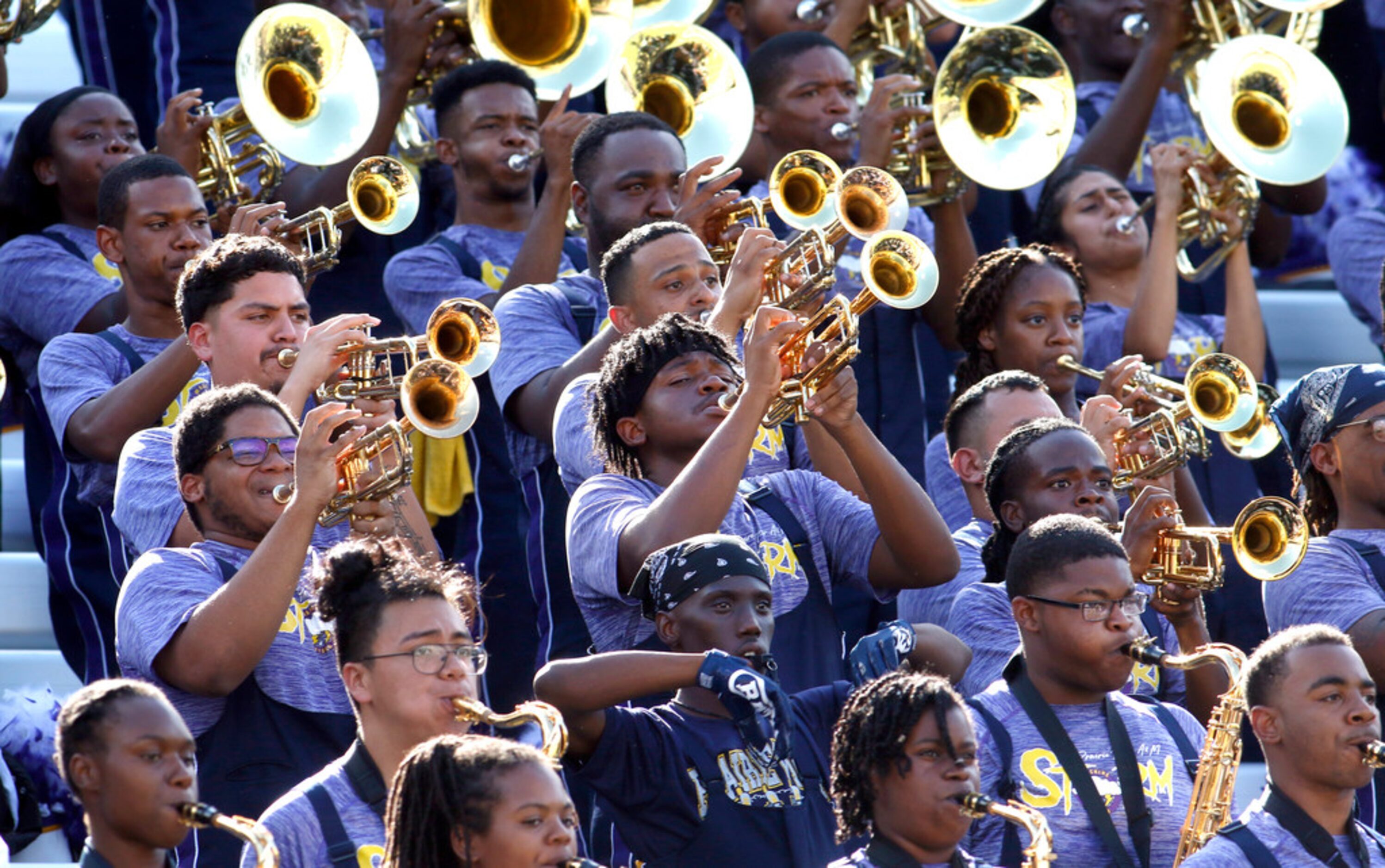 Members of the Prairie View band perform from the stands behind the team bench following a...