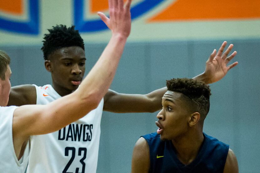 Little Elm guard Devin Pullum (3) is double-teamed by McKinney North guards Malik Perry (23)...