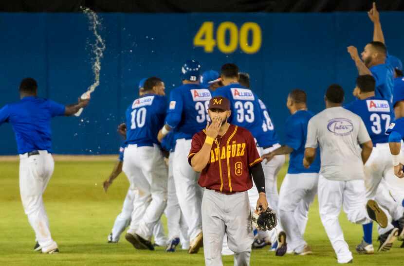 Indios de Mayaguez center fielder Jay Gonzalez walks off the field as the Cangrejeros de...