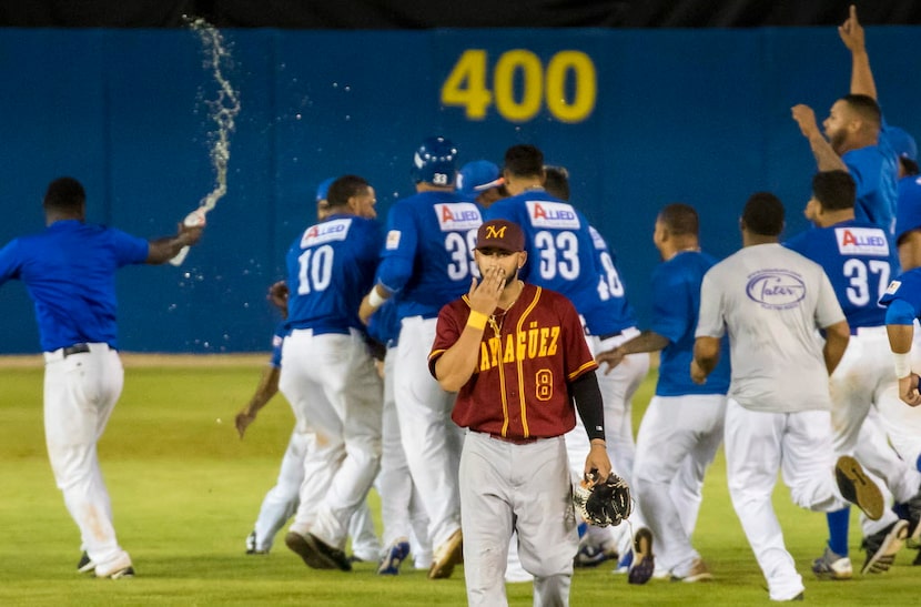 Indios de Mayaguez center fielder Jay Gonzalez walks off the field as the Cangrejeros de...