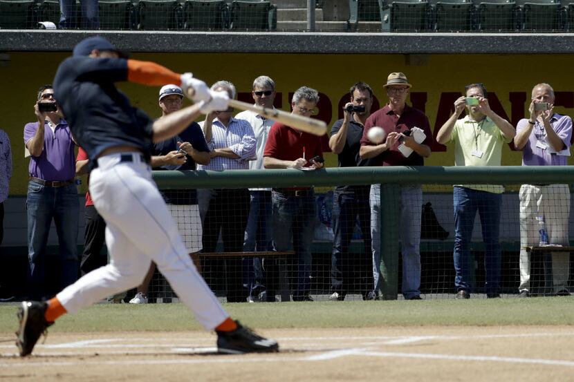 Baseball scouts and the media watch a showcase for former NFL quarterback, Tim Tebow at the...
