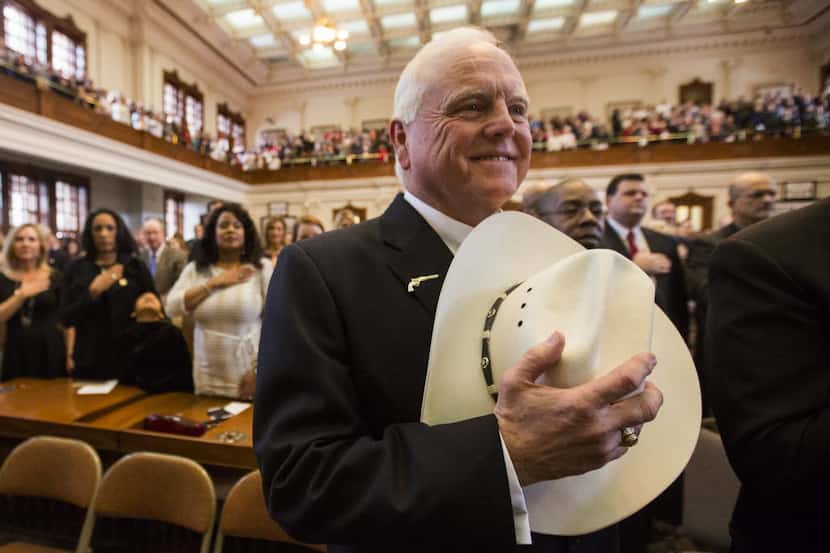 Agriculture Commissioner Sid Miller held his cowboy hat over his heart during the singing of...