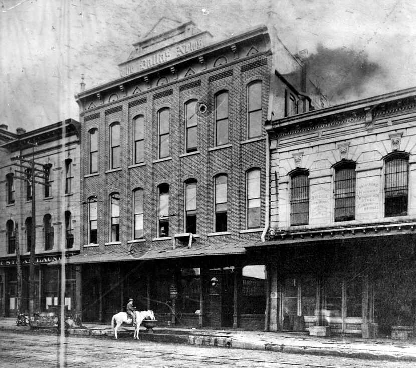 The Dallas News building, on Commerce Street between Lamar and Austin, circa 1885. Next to...