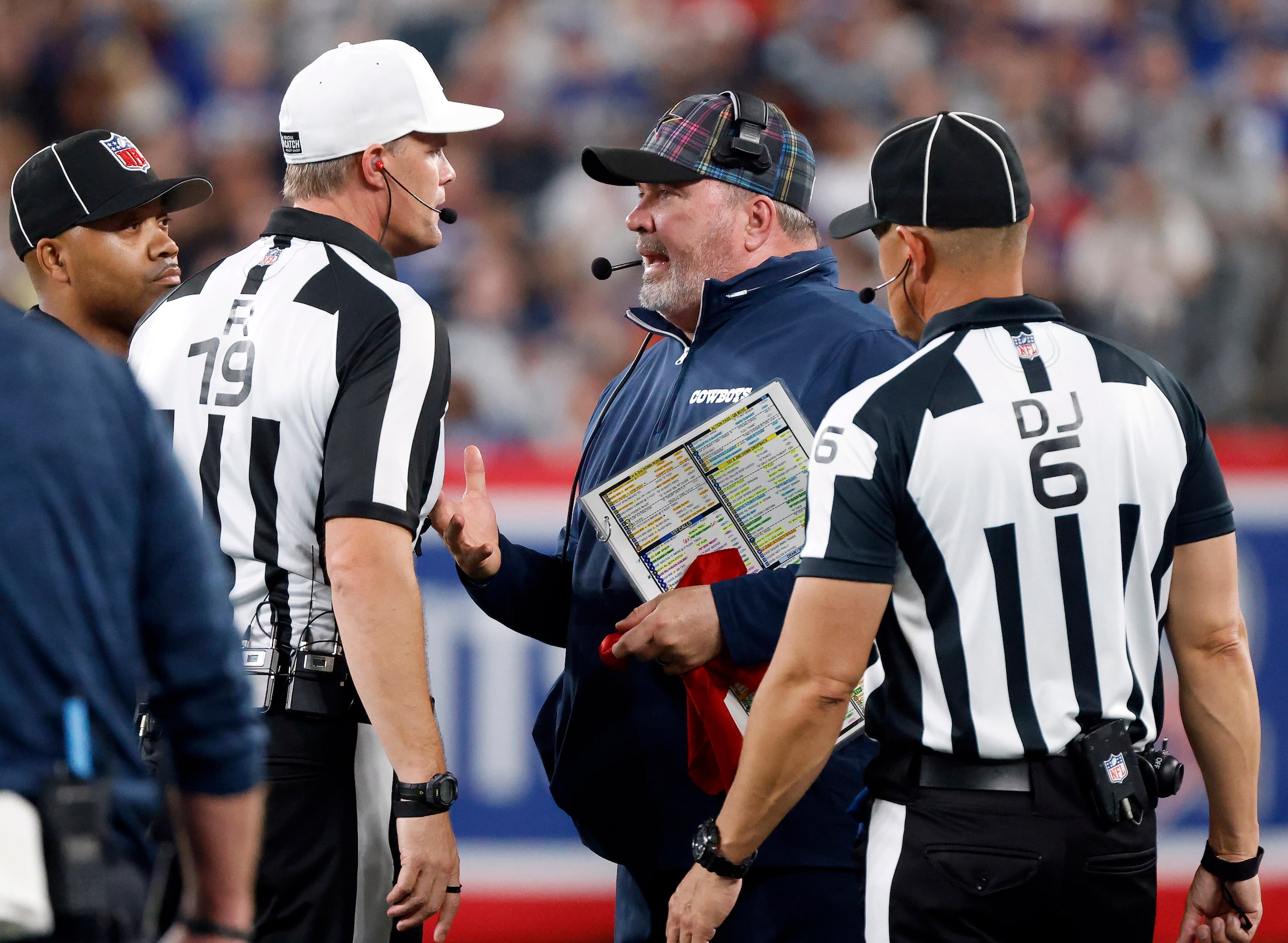 Dallas Cowboys head coach Mike McCarthy makes his argument with referee Clay Martin (19)...