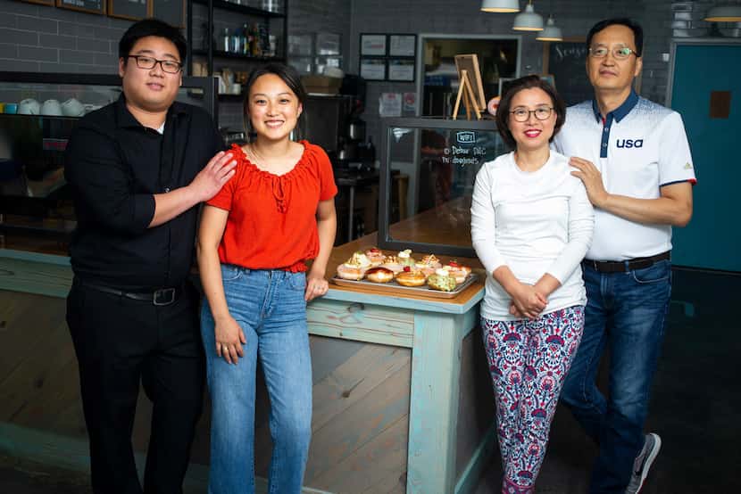 KJ Park (left) poses for a photograph with his wife, Jinny Cho, owner of Detour Doughnuts...