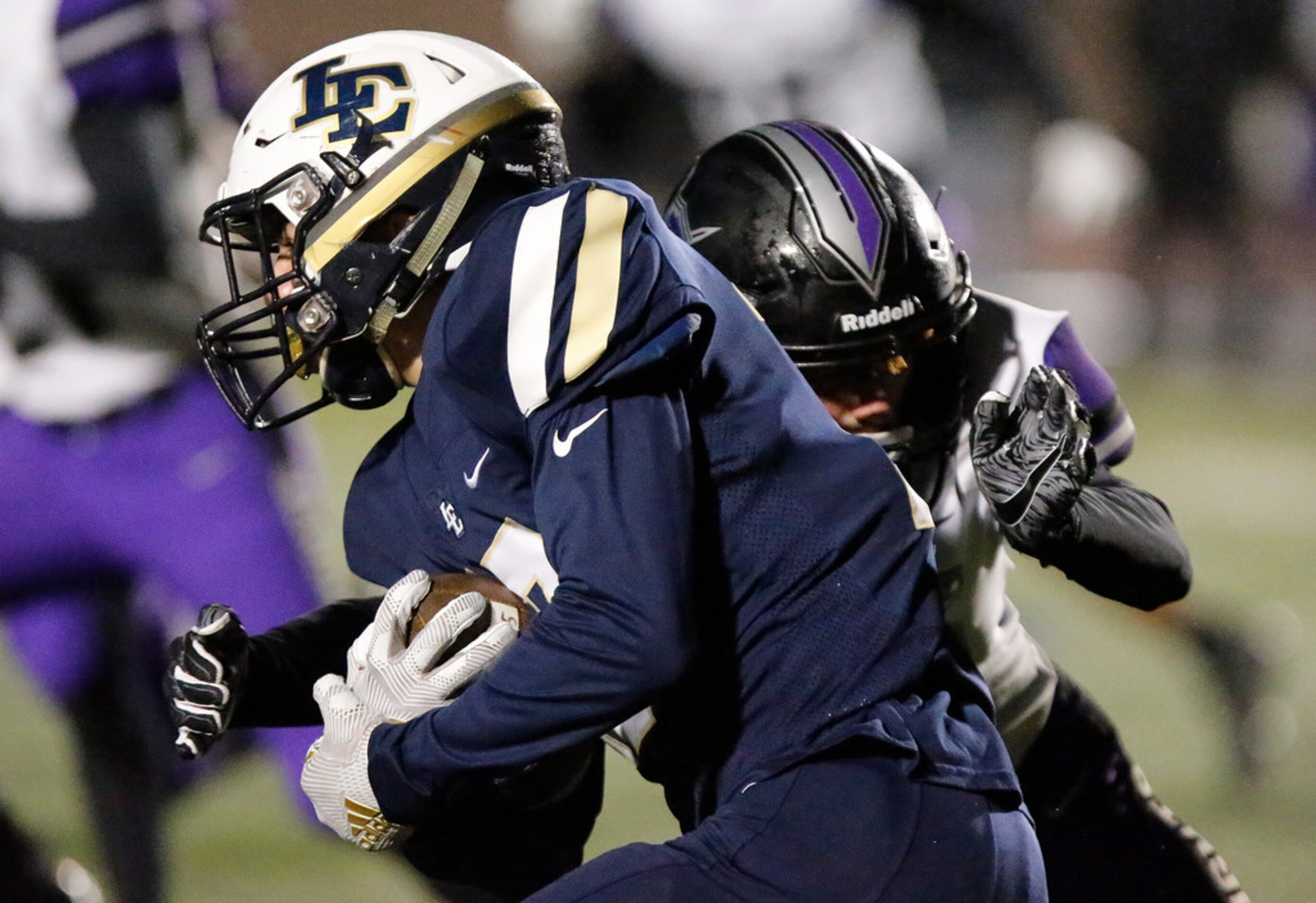 Little Elm High School kick returner Andrew Bishop (17)  is met by Independence High School...