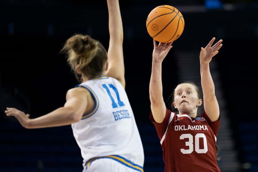 Oklahoma guard Taylor Robertson (30) shoots over UCLA forward Emily Bessoir (11) during the...