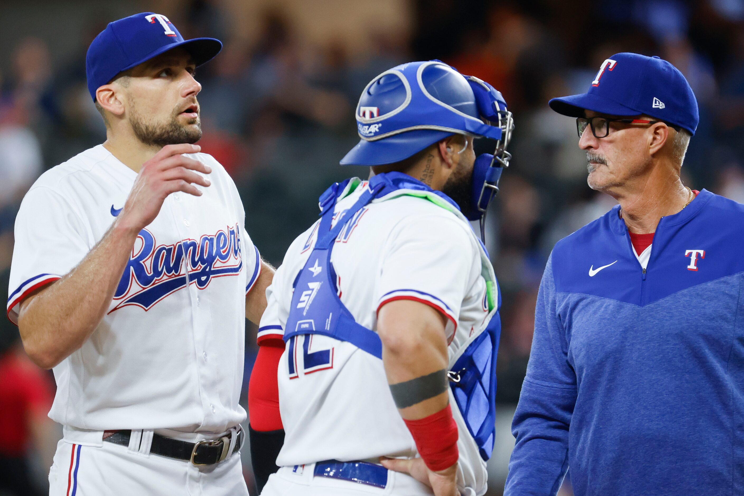 Texas Rangers starting pitcher Nathan Eovaldi (left), catcher Sandy Leon talk to pitching...