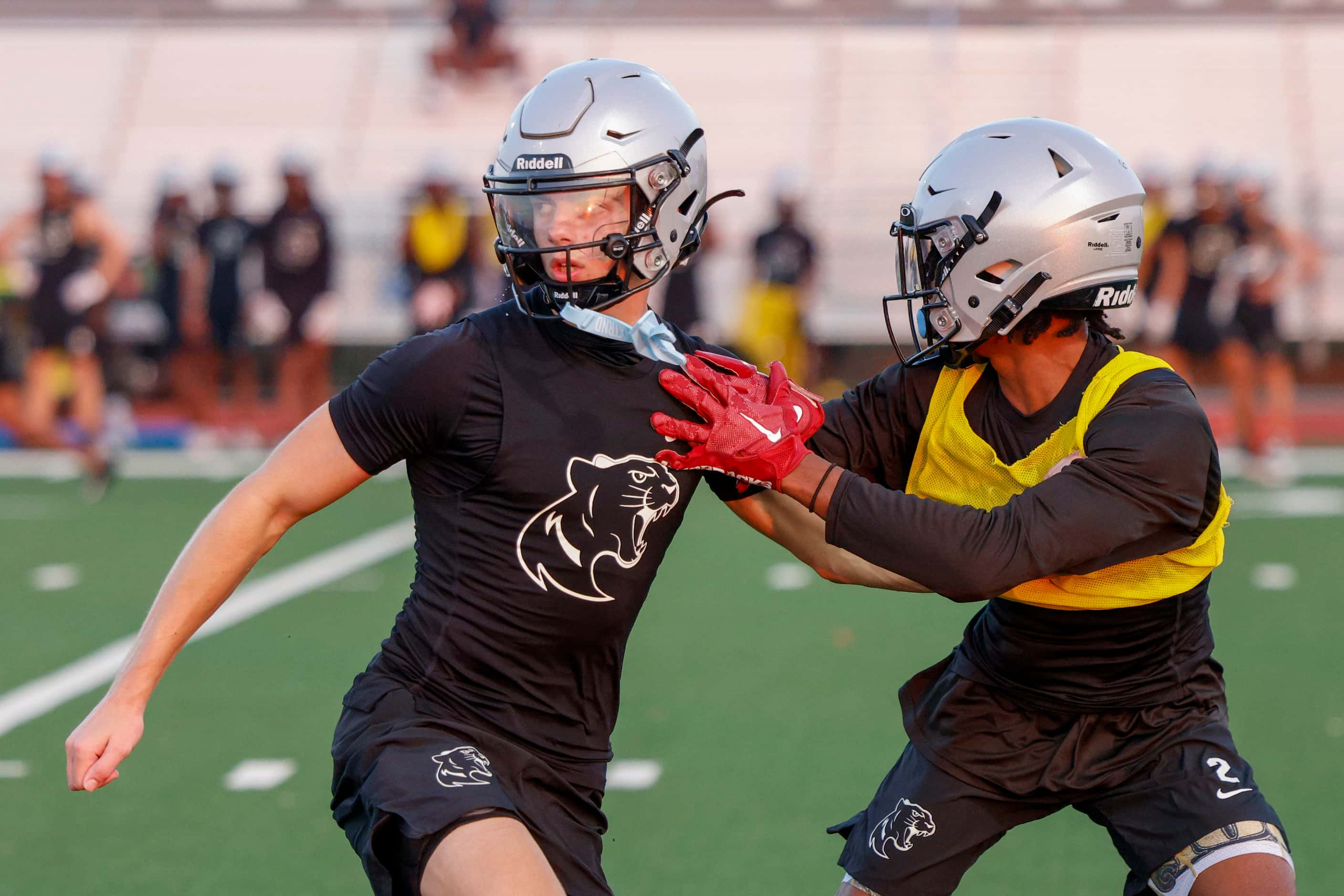 Wide receiver Cristian Trickett (left) runs a route against a defensive back during an early...