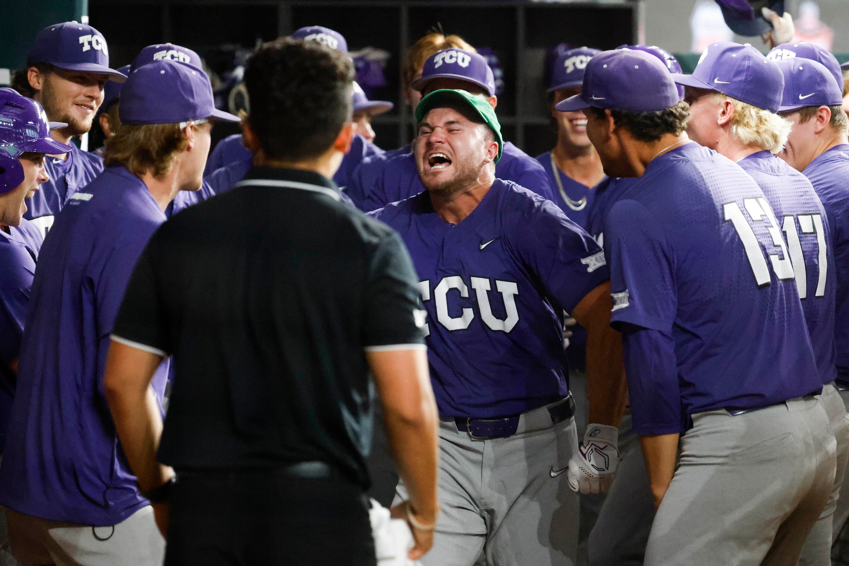 TCU outfielder Luke Boyers (front) cheers in the dugout after a three run homer during the...