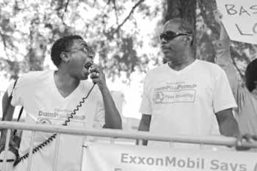  C.D. Kirven (left) and Michael Robinson were outside the Exxon Mobil shareholders meeting...