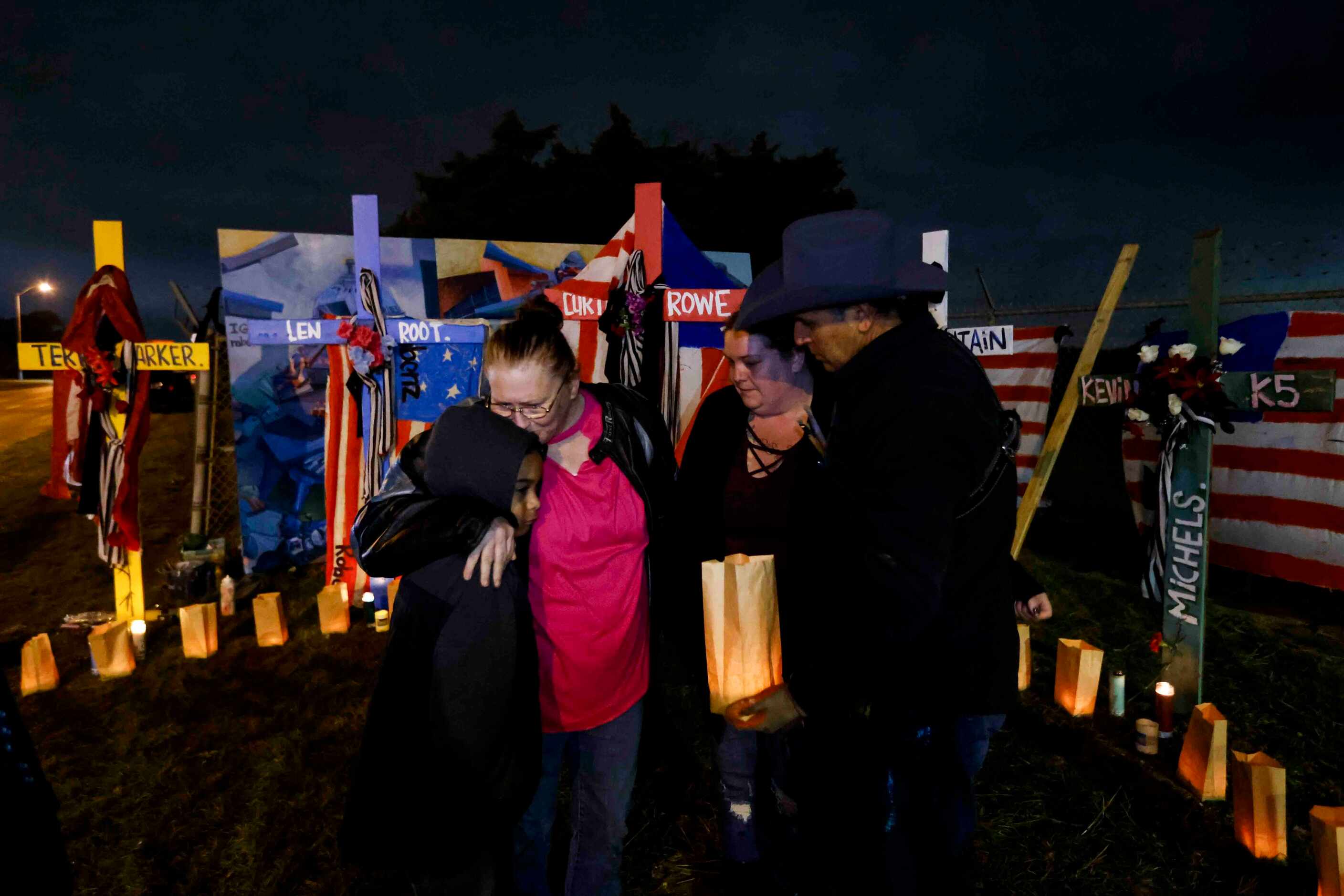 Diane Holley, left, of Hutchins embraces her grandson Rilei Webb, 8, as his mother Christy...