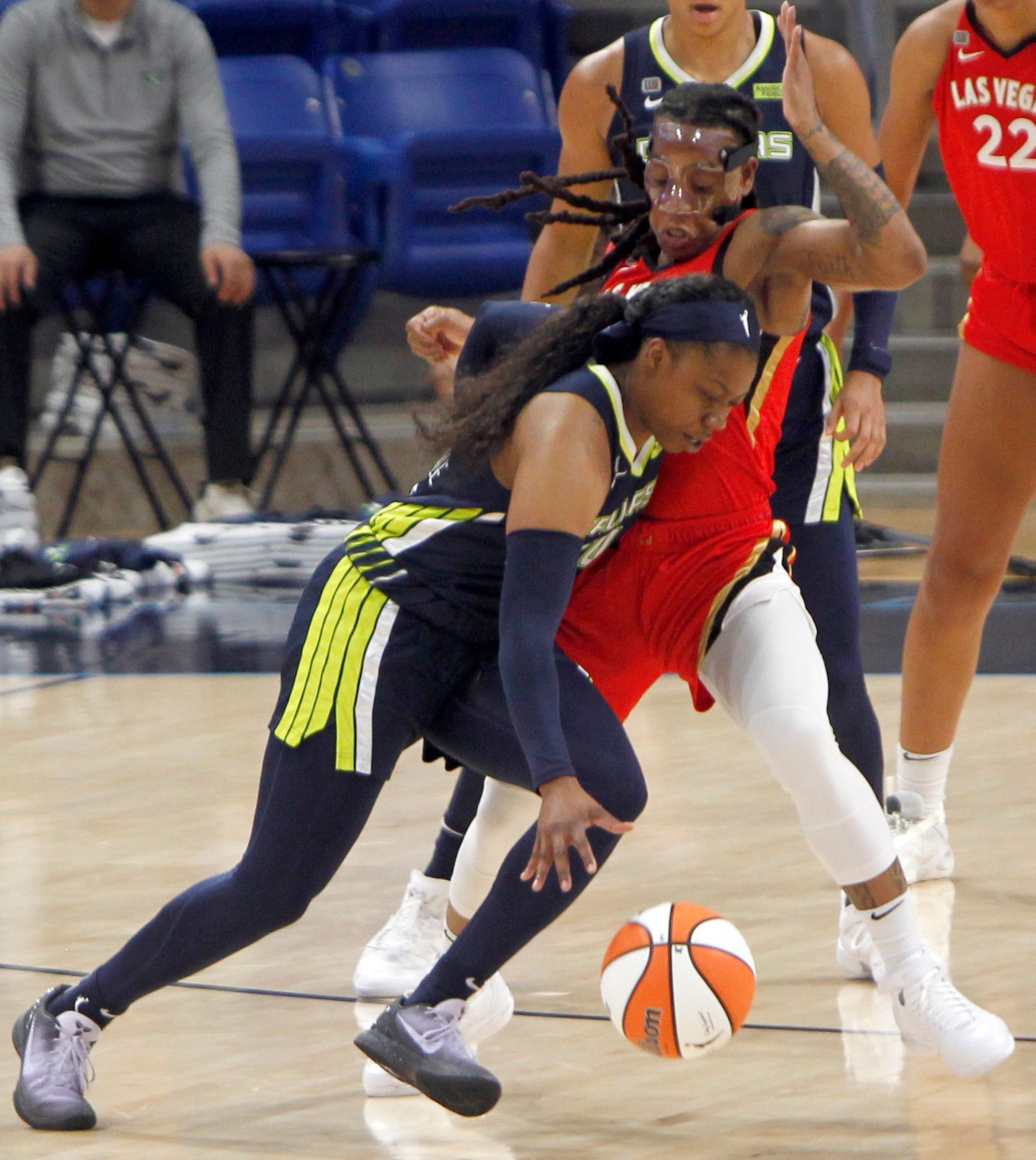 Dallas Wings guard Arike Ogunbowale (24) drives into the defense of Las Vegas guard Riquna...