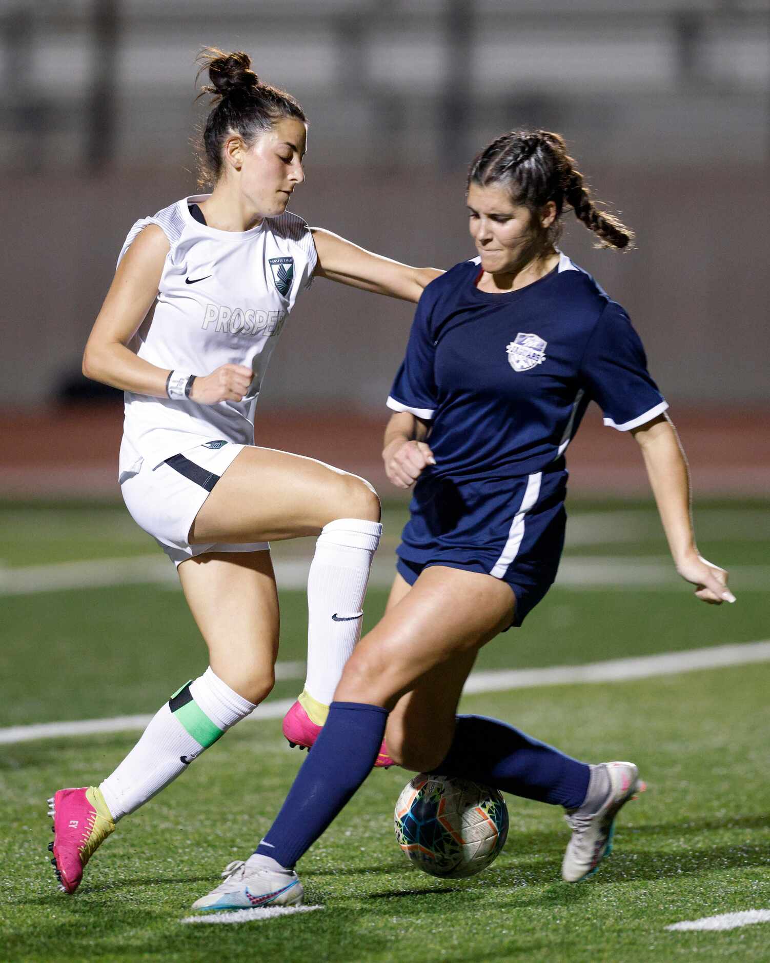 Flower Mound back Madison Vloitos (right) tackles the ball away from Prosper midfielder Emma...
