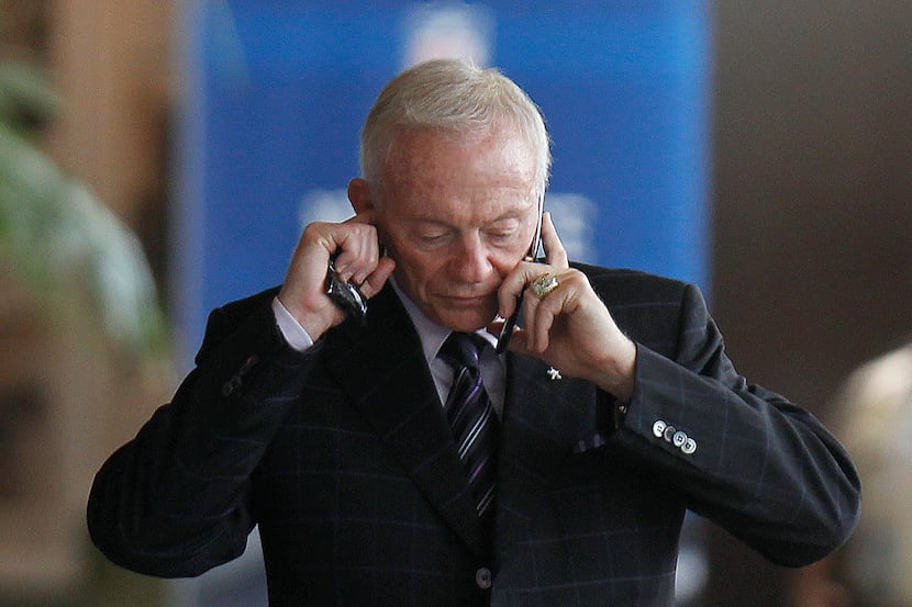 Dallas Cowboys owner Jerry Jones talks on his phone during an NFL owners labor committee...