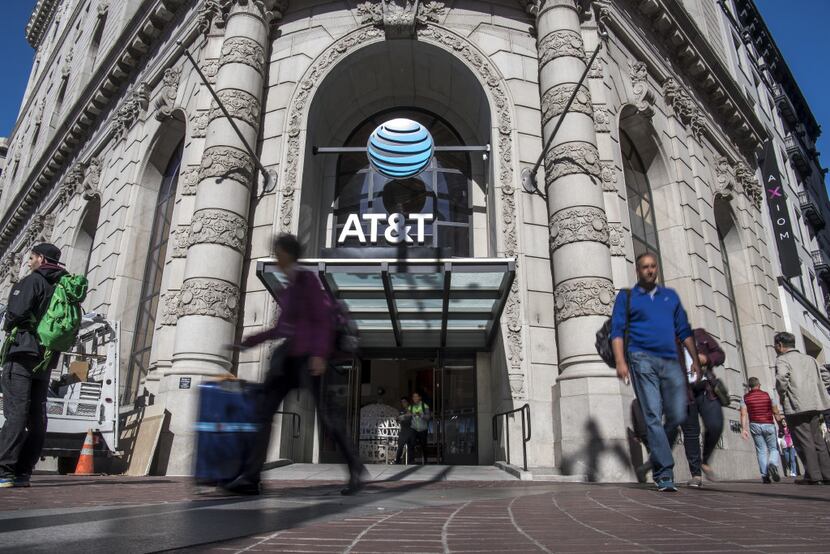Pedestrians walk past the AT&T Corp. west coast flagship store in San Francisco, California,...
