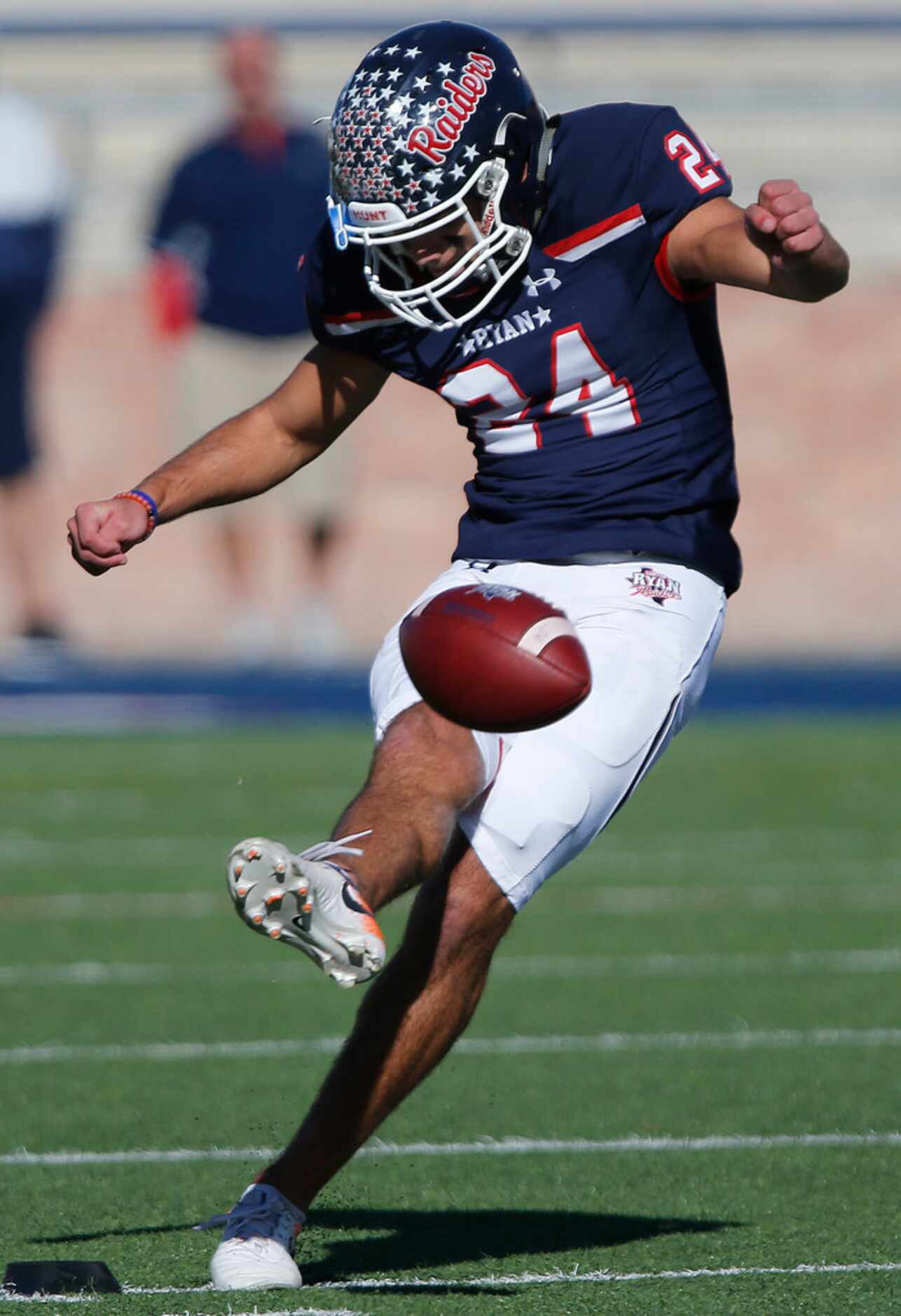 Denton Ryan High School Riley Nuzzo (24) launches the opening kickoff to start the game as...
