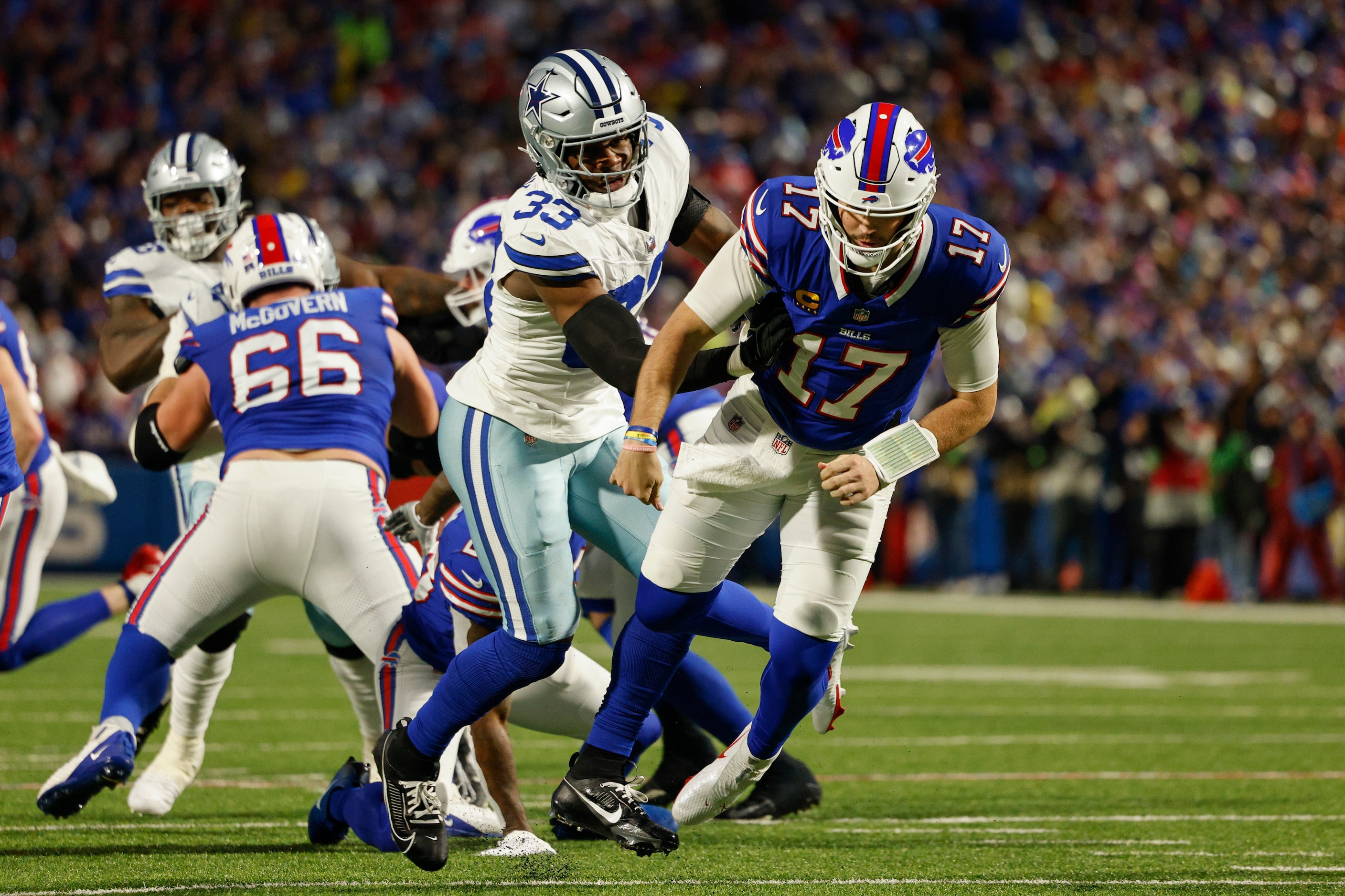 Dallas Cowboys linebacker Damone Clark (33) hits Buffalo Bills quarterback Josh Allen (17)...