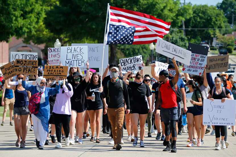 Protesters marched beside the Plano Police Department on Wednesday at a rally organized by...