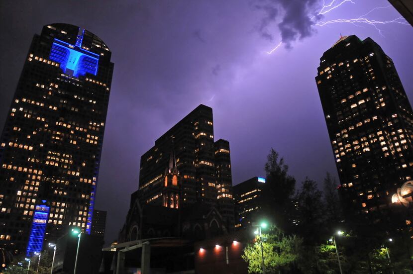 Lighting illuminates part of the downtown Dallas skyline over the Arts District in Dallas on...