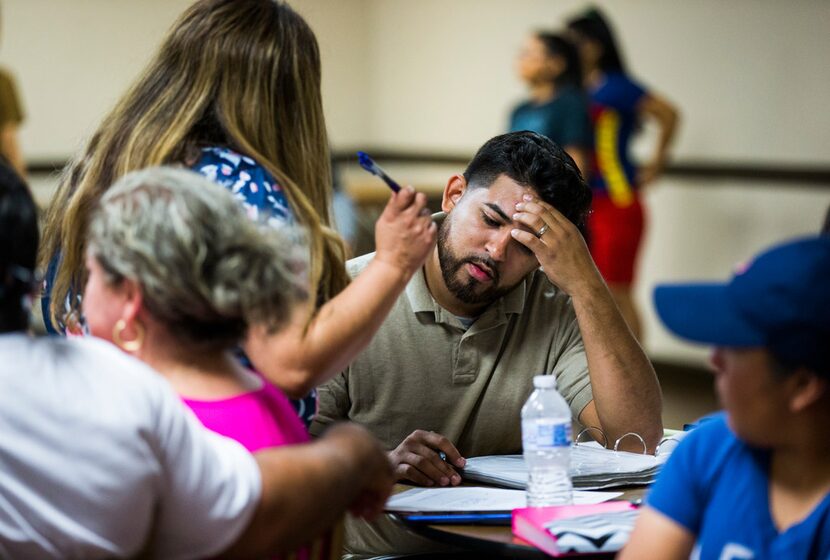 David Hernandez, owner and founder of the Latin Boyz Cadets, talks to a client during a...