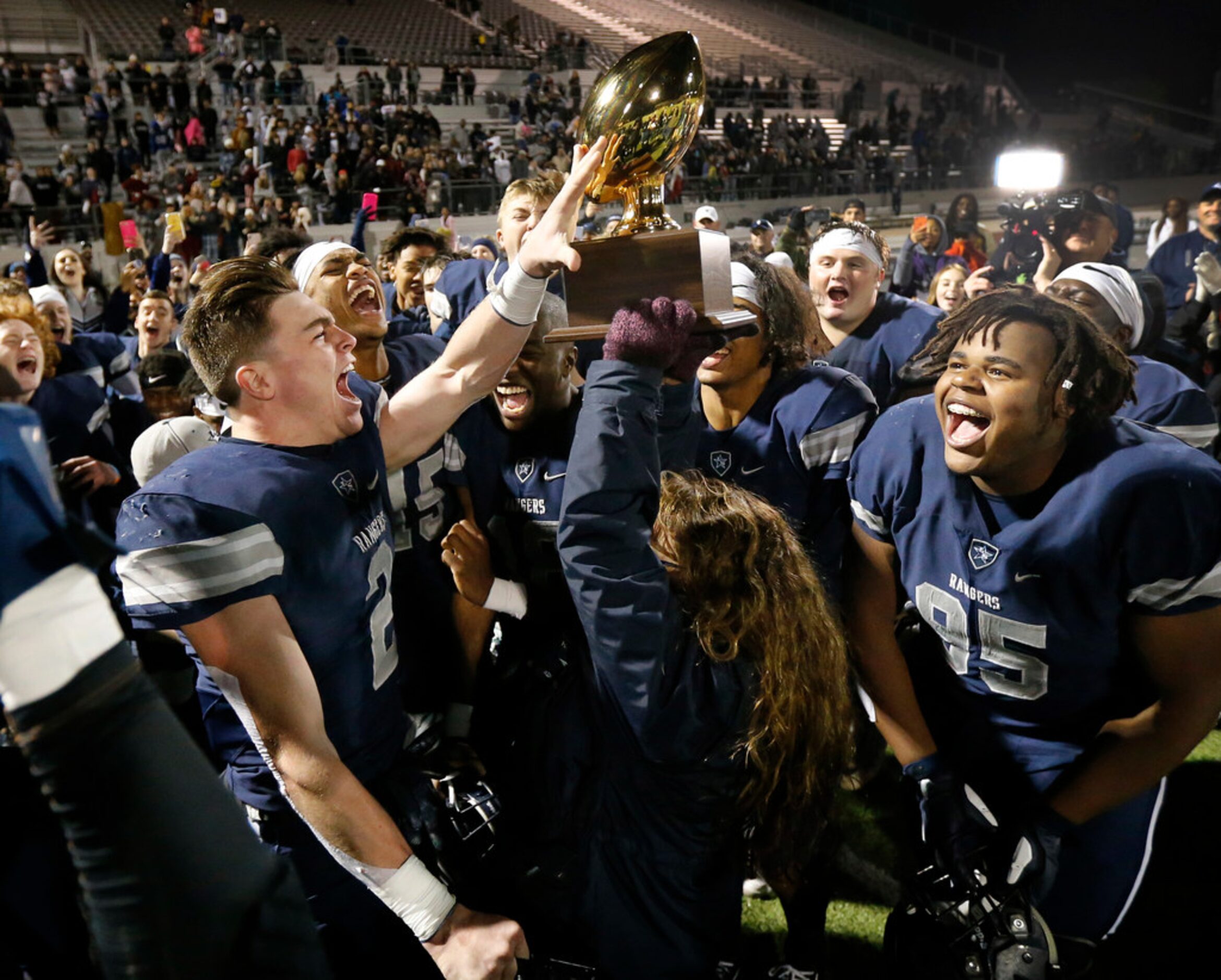 Frisco Lone Star players including receiver Jake Bogdon (2) and Cameron Jones (95) celebrate...