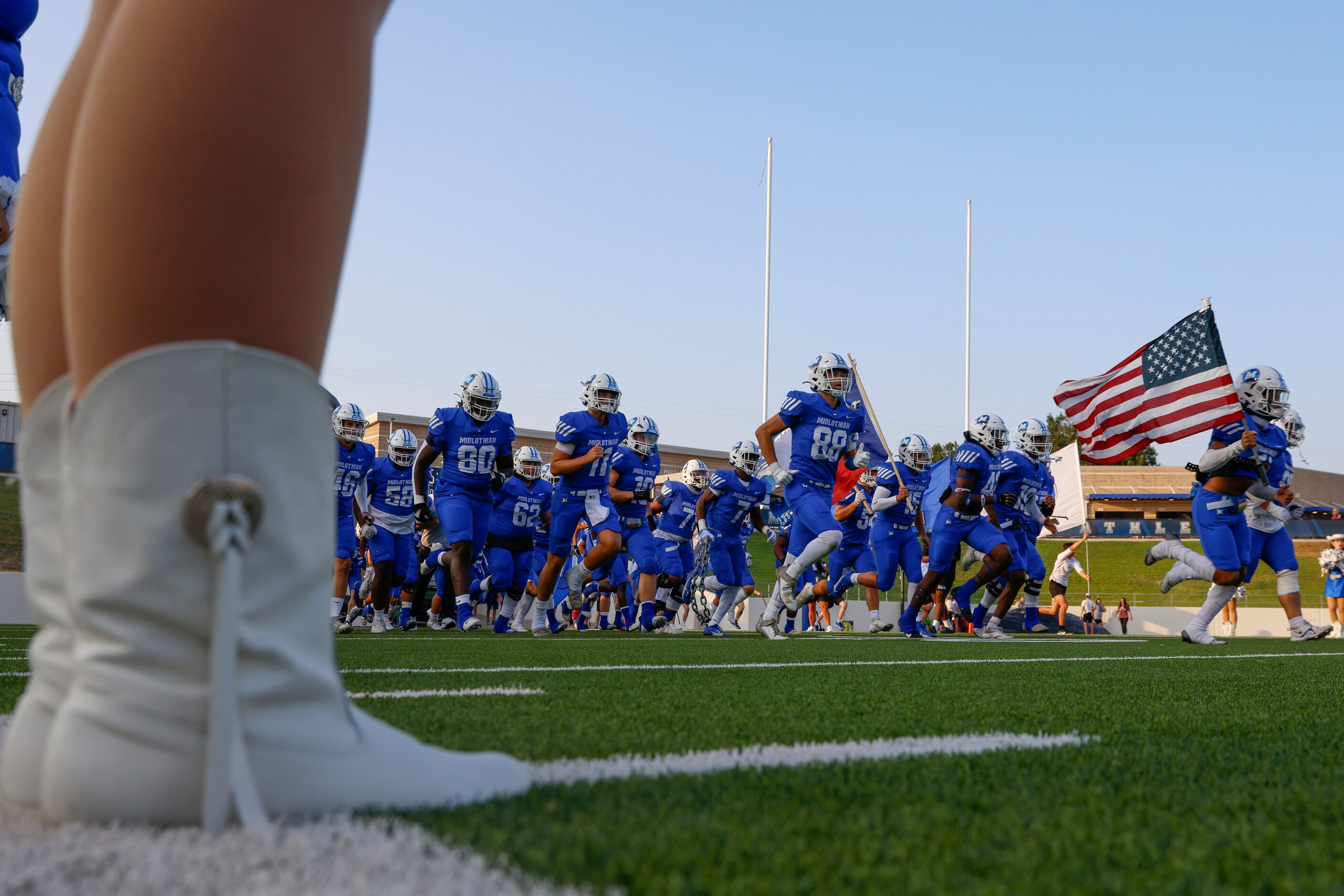 Midlothian high school players enter the field ahead a football game against Ennis High on...