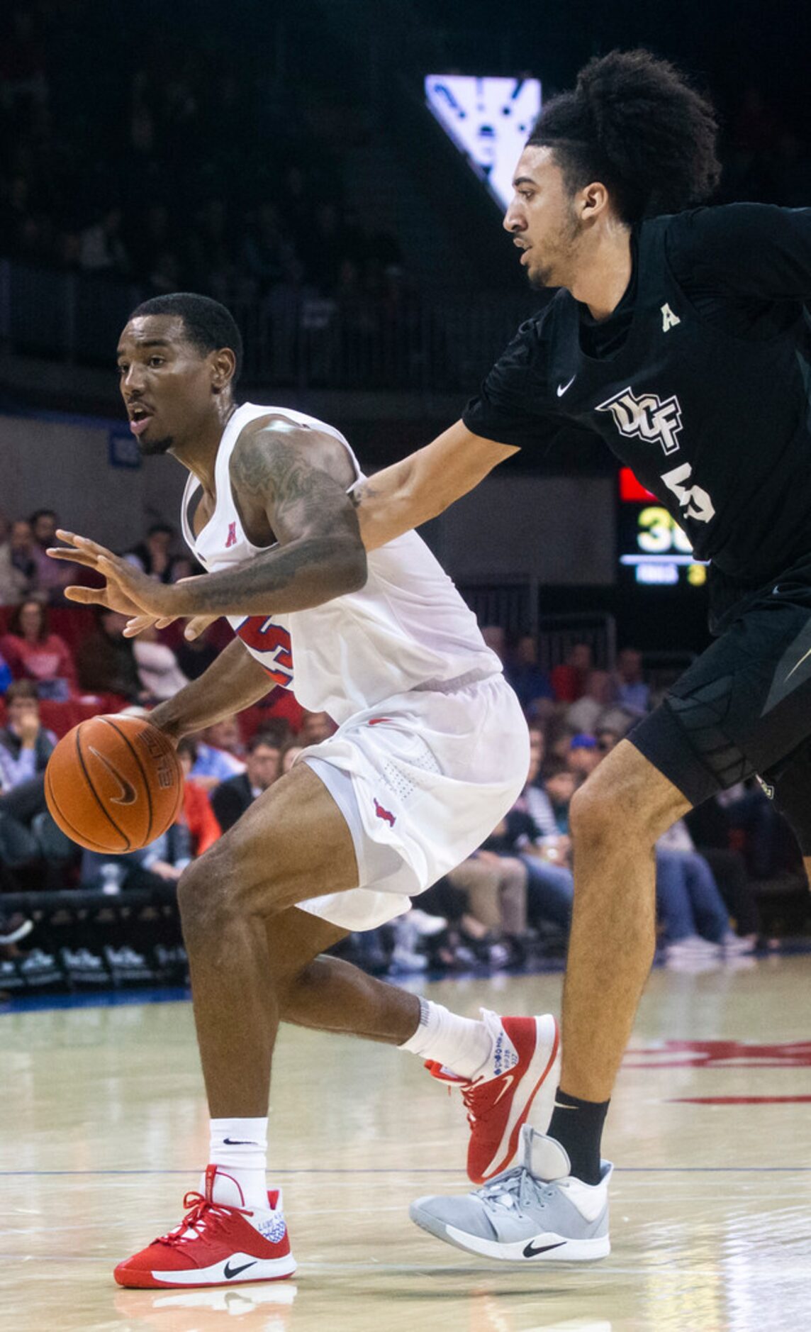 Southern Methodist Mustangs forward Isiaha Mike (15) tries to maneuver past UCF Knights...