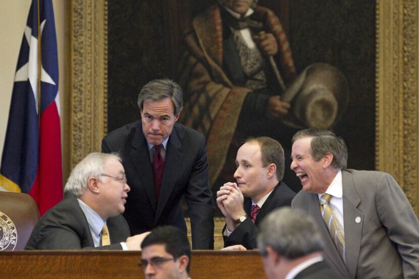 House Speaker Joe Straus (left center), seen conferring with fellow legislators at the...