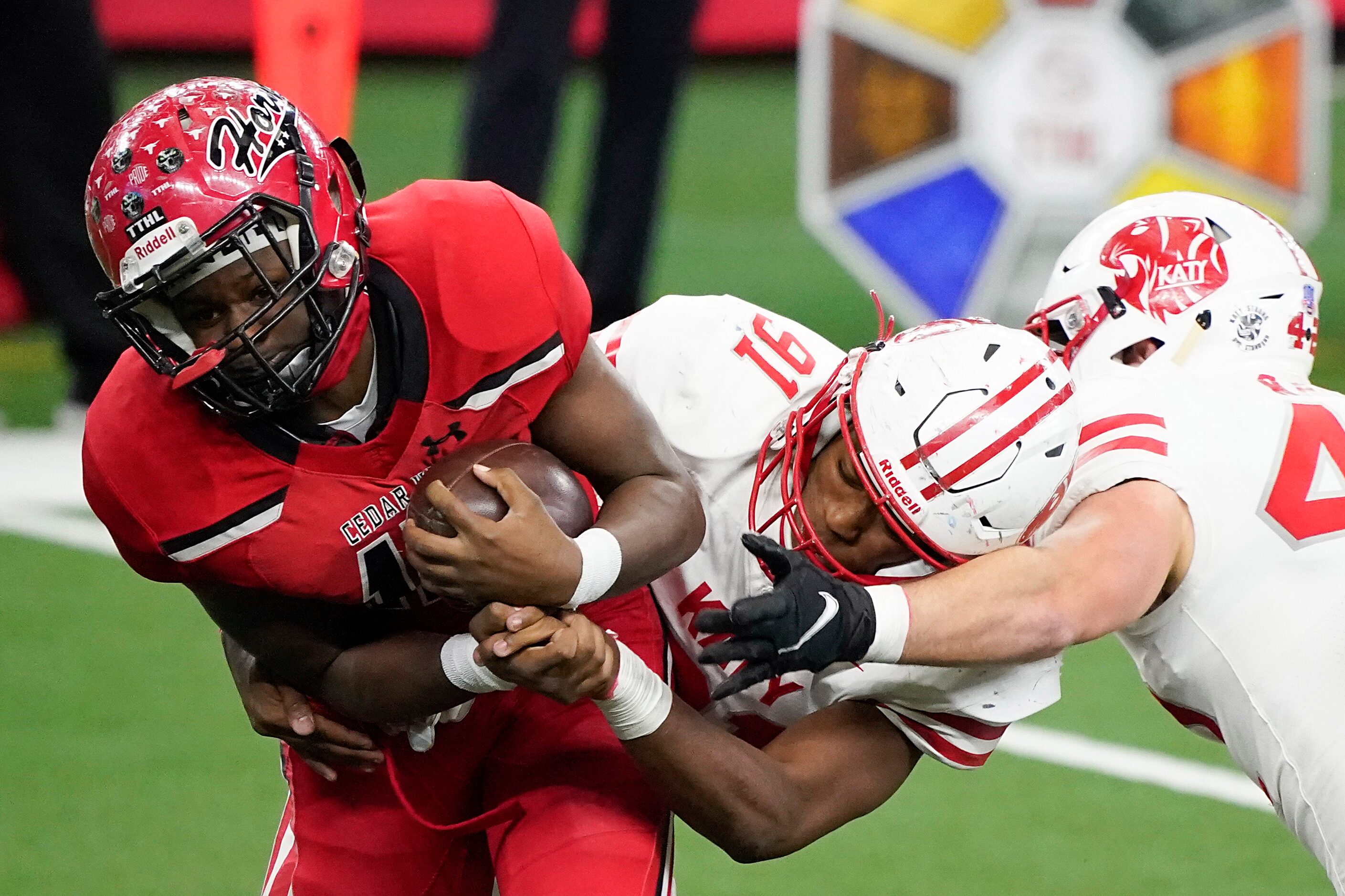 Cedar Hill wide receiver Dewayne Blanton (15) is wrapped up by Katy defensive lineman Cal...